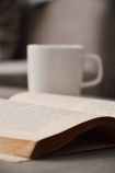 white book beside white mug